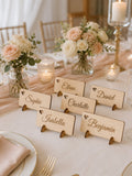 Personalized laser engraved wooden place cards with guest names on wedding table