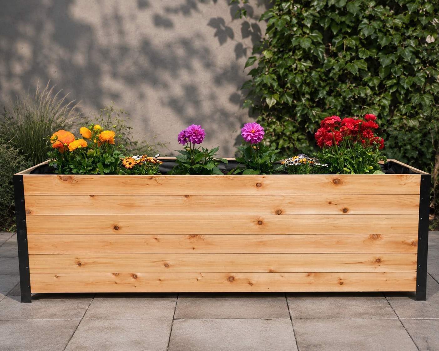 Rectangular wooden planter box with metal corner accents filled with colorful flowers
