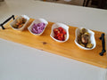 Personalized wood serving board with 4 white bowls filled with appetizers