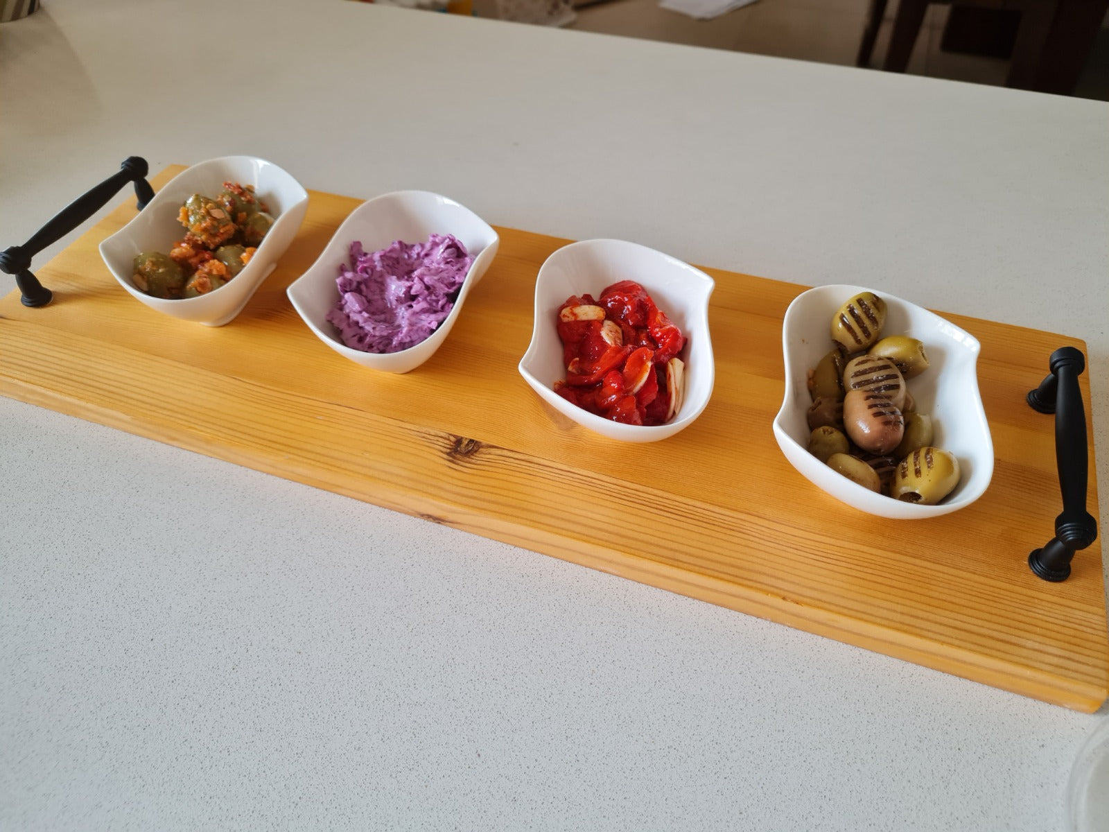 Personalized wood serving board with 4 white bowls filled with appetizers