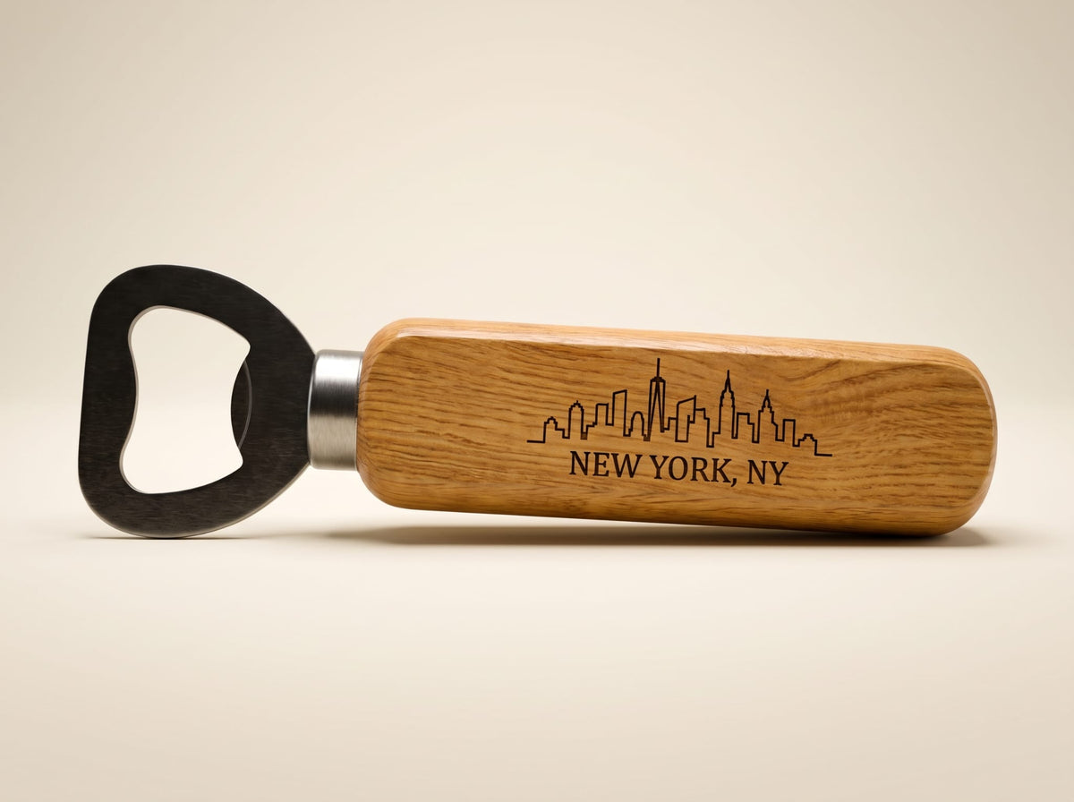 A wooden bottle opener with a black metal pull tab and a silver metal collar, featuring an engraved New York City skyline and 'NEW YORK, NY' text on the handle, set against a plain beige background.