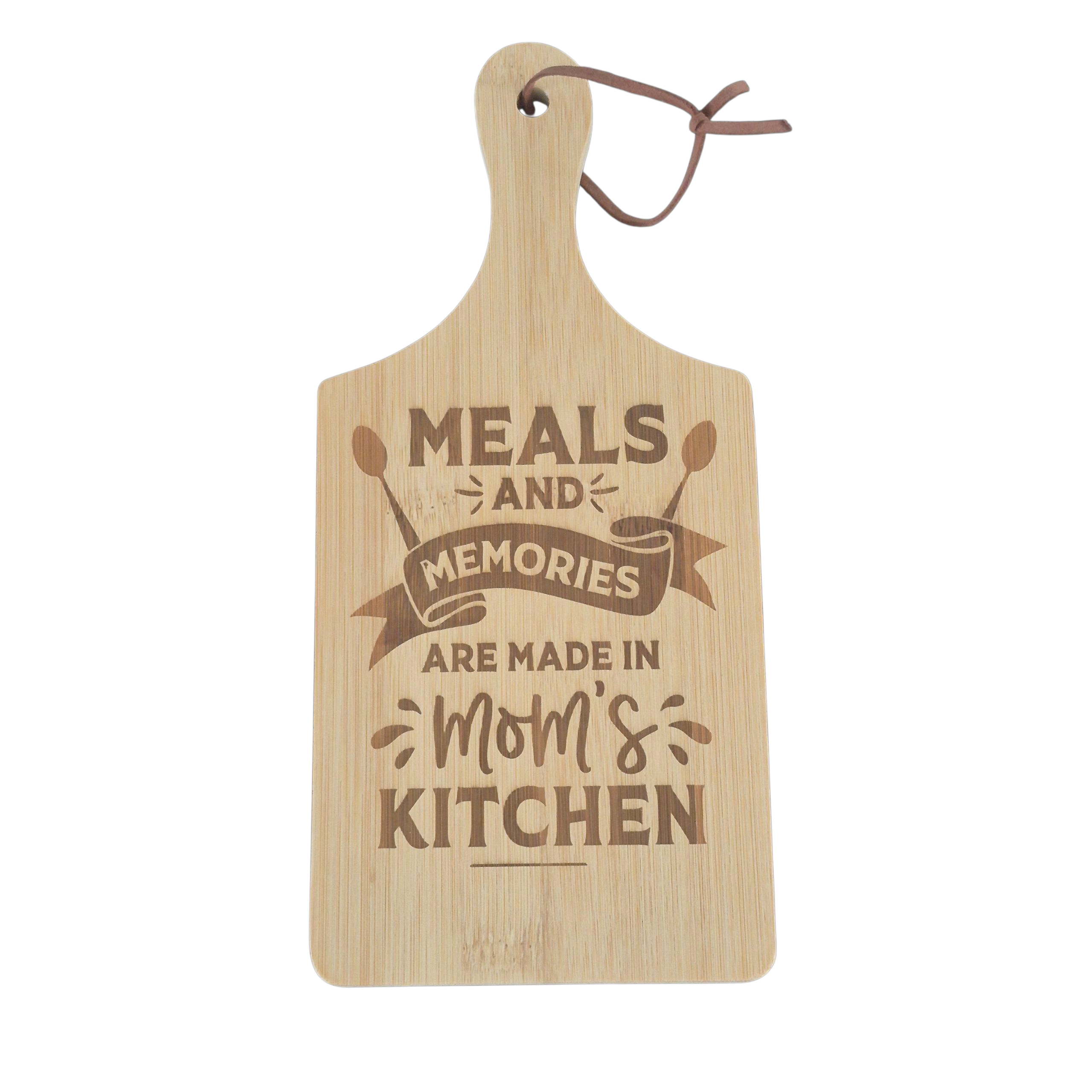 A light natural wood cutting board with a handle and a hanging loop, featuring the engraved text 'MEALS AND MEMORIES ARE MADE IN Mom's KITCHEN' in a darker brown tone, shown on a plain white background.